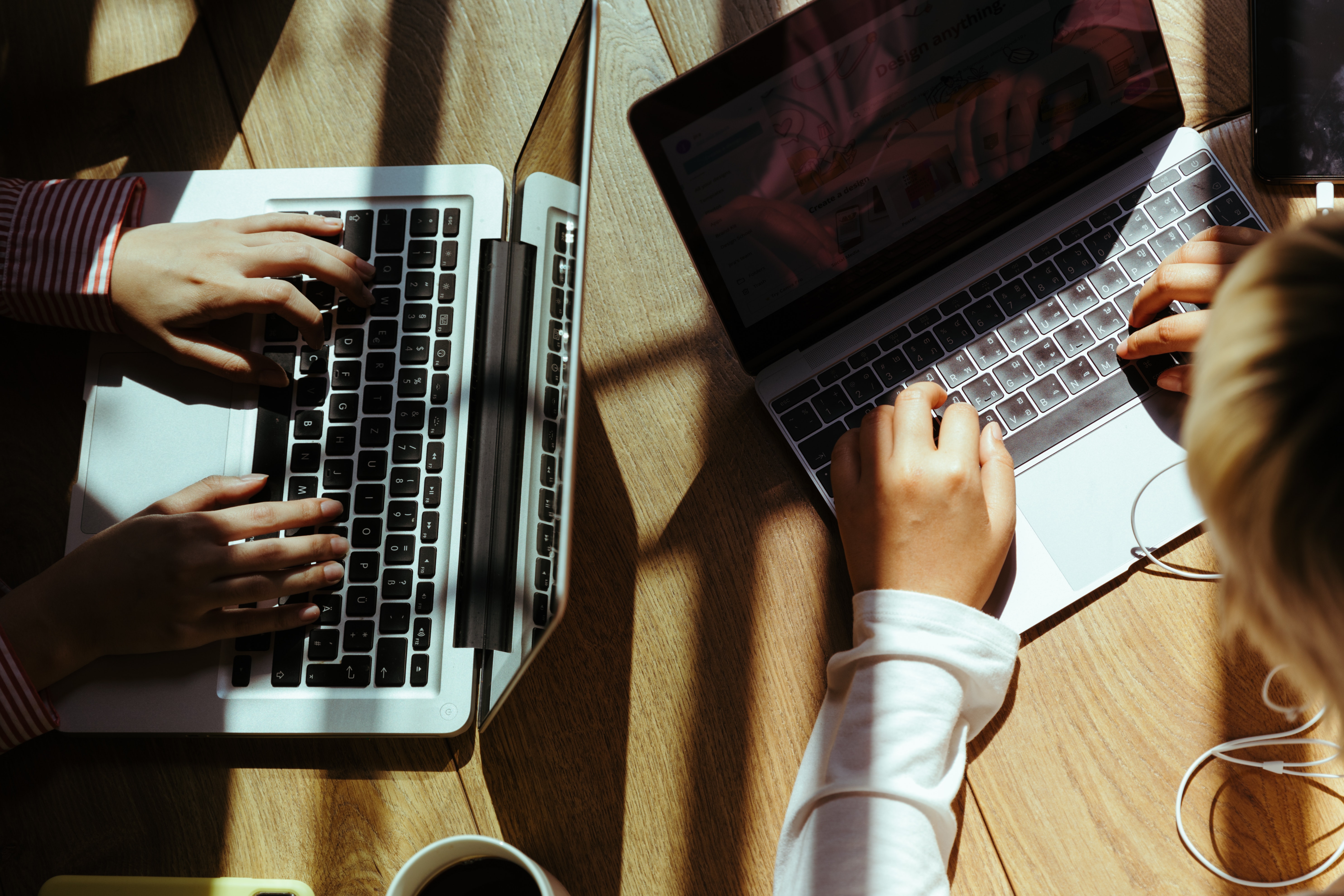 person-using-macbook-pro-on-brown-wooden-table-4132310